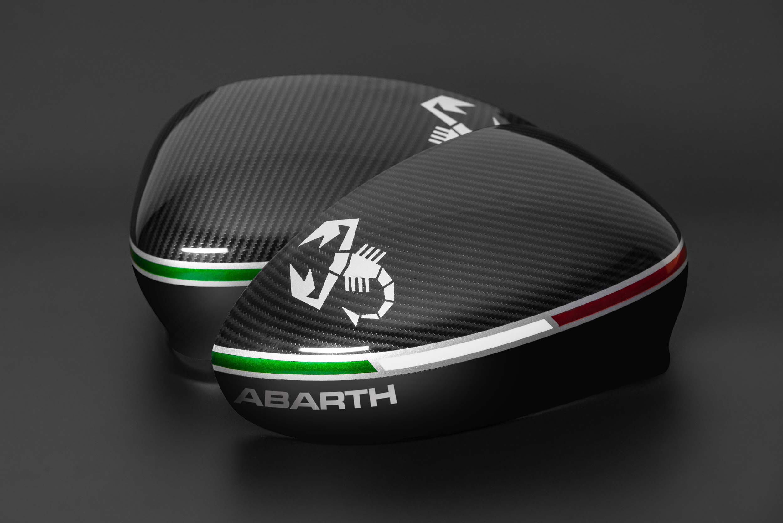 Close-up of scorpion emblem on carbon-look Abarth mirror cover