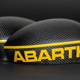 abarth carbon mirror caps with reflective yellow inscription