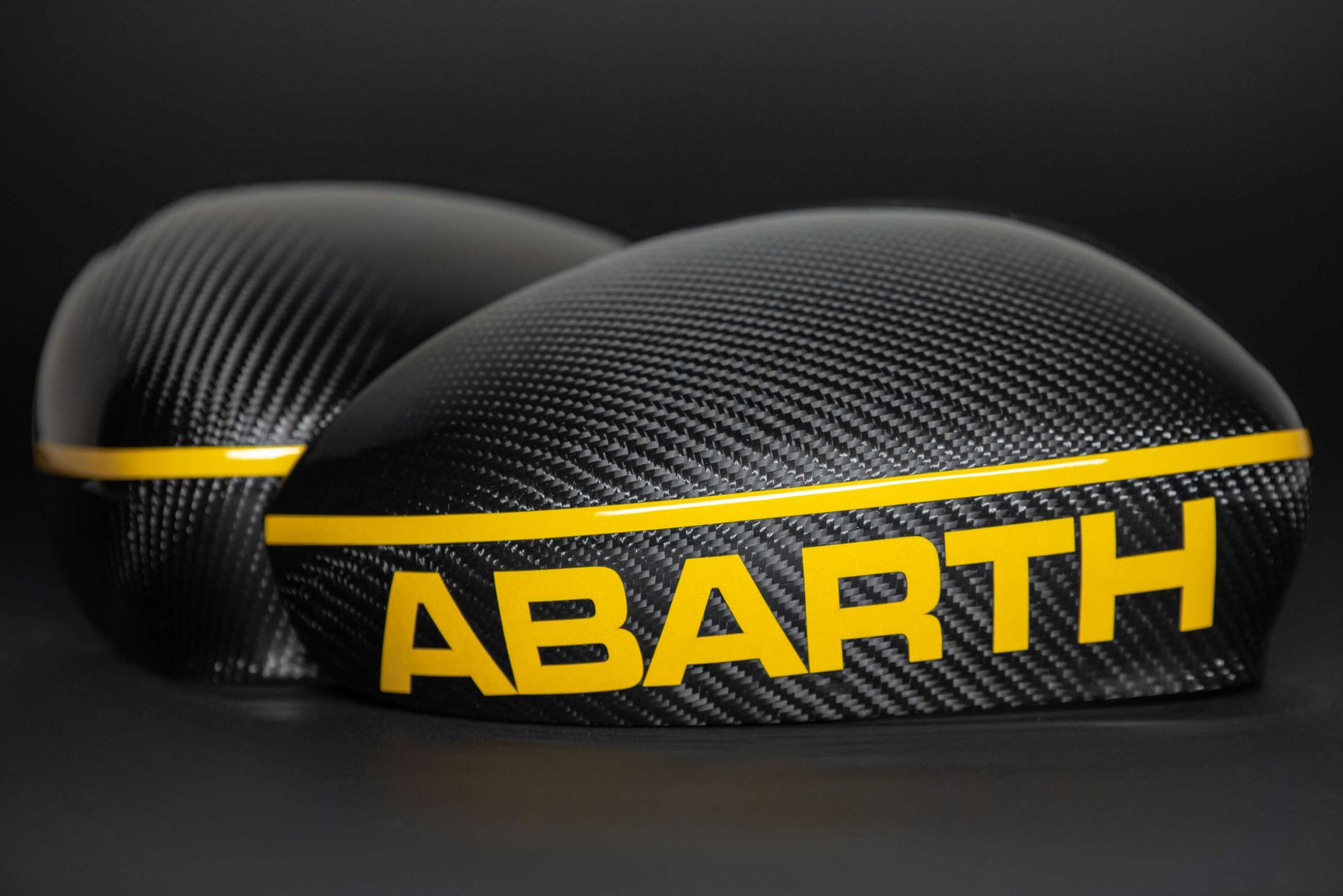 abarth carbon mirror caps with reflective yellow inscription